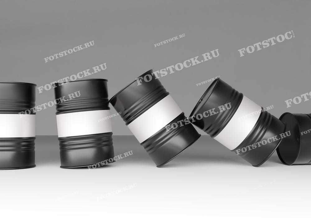 На фотографии изображены черные бочки с нефтью, падающие на сером фоне. Движение бочек символизирует нестабильность и кризис в нефтяной отрасли, отражая падение цен на нефть или экономические потрясения в энергетическом секторе.